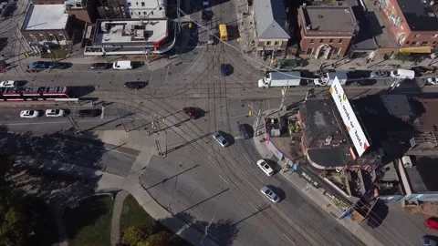 Aerial birds eye view of an intersection in Toronto with streetcar tracks and ca Stock Footage 151980215