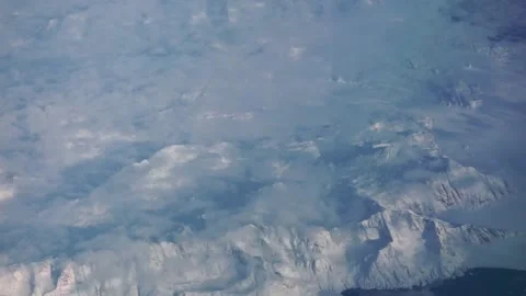 Aerial: blanket of cloud overlying mountains in South Eastern Greenland Stock Footage 235650382