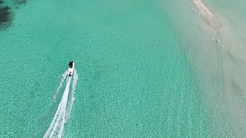Aerial bliss is experienced aboard a high-speed boat with clear waters and Stock-Footage 259094544