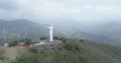 Aerial blowing past the front face of Cristo Rey statue to the mountains Stock-Footage 78680342
