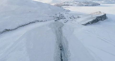 Aerial Boat Float Along Empty Snow Covered Surface of Frozen Lake Baikal Stock Footage 124677029