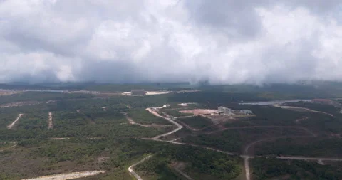 Aerial: Bokor Mountain development and resorts emerging from forest under clouds Stock Footage 333517679