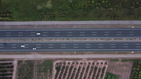 Aerial bottom view of horizontal highway next to farm fields Stock-Footage 159748715