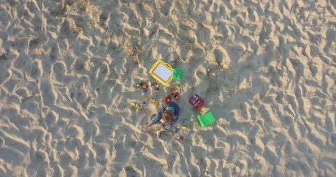 Aerial of boy sitting at beach Stock Footage 89963598
