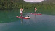 Aerial: Boyfriend And Girlfriend Stand Up Paddling On Sup Boards Stock Footage