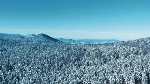 Aerial breathtaking shot of distant cold lonely mountains surrounded with snow Stock Footage 107391338