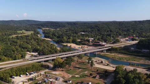 Aerial of bridge and river in forested rural landscape in Van Buren Missouri Stock Footage 344753033