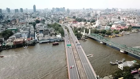 Aerial of Bridge &amp; River with Boats Passing Through in Bangkok Thailand Stock-Footage 123715003