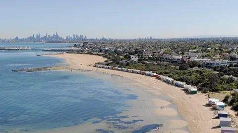 Aerial of Brighton Bathing Boxes in Melbourne from the ocean with city, orbit Stock Footage 97149339