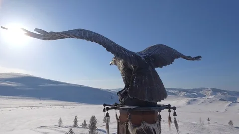 Aerial Bronze Monument Stella Eagle Shaman Buryatia Baikal Mountains Winter snow Stock Footage 88029789