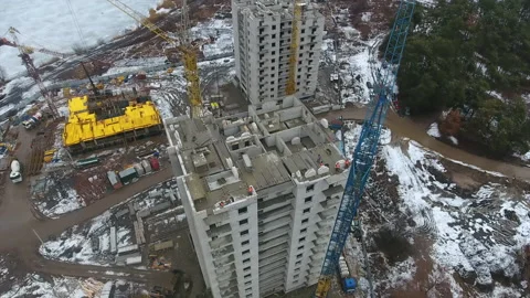 Aerial of building skyscraper with workers on top Stock Footage 152448846