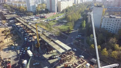 Aerial building tower crane highway road car traffic road construction in the ci Video stock 56207953