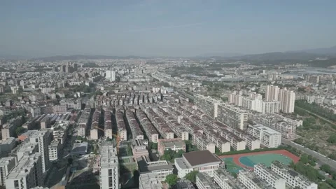 Aerial: Buildings In The Developing Town of CHINA On Sunny Day Morning Video stock 219379313
