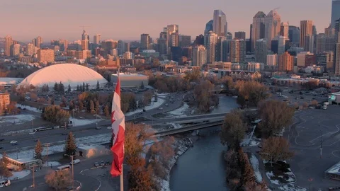 Aerial: Calgary city skyline and Canadian flag. Alberta, Canada. Stock Footage 119876053
