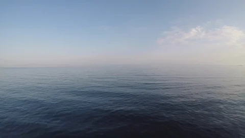 Aerial: Calm ocean at sunset Stock Footage 89324916