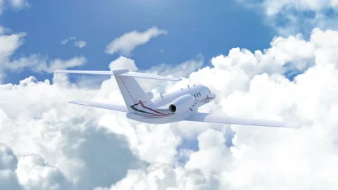 Aerial  camera chasing a private jet flying above the clouds Stock Footage 124544288