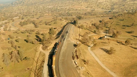 The aerial camera continues following the train passing over the loop Stock Footage 101222691