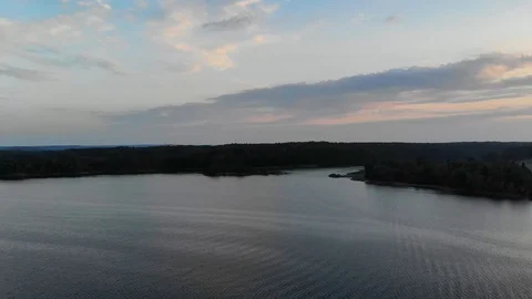 Aerial camera crane down on archipelago water during a colorful sunset Stock Footage 96656731