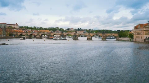 Aerial camera flies fast along the Charles Bridge in Prague as the cloudy day Stock Footage 103223093