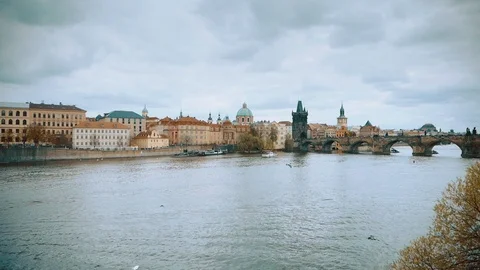 Aerial camera flies fast along the Charles Bridge in Prague as the cloudy day Stock Footage 103223372