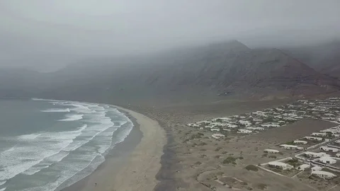 Aerial camera flight up of the ocean coast city with cloudy mountains Stock Footage 85287192
