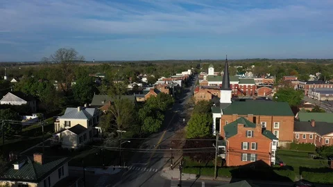 Aerial camera flying low towards the courthouse in Charles Town, WV in early Stock Footage 129620989