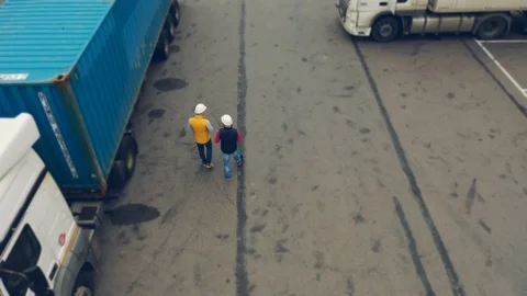 AERIAL. Camera following for Two workers, two drivers works on tablet near Stock Footage 111405273