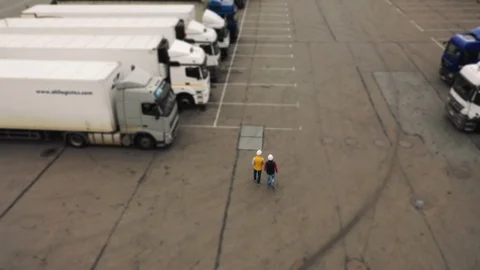 AERIAL. Camera following for Two workers, two drivers works on tablet near Stock Footage 111405360