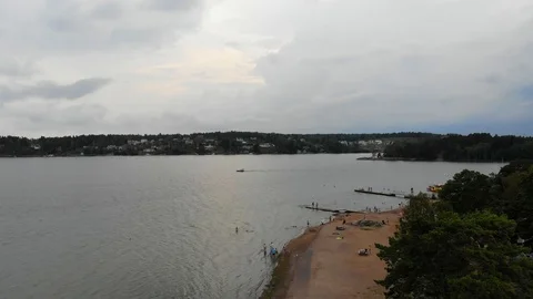 Aerial camera goes down on a beach near archipelago with forest in background Stock Footage 96652873