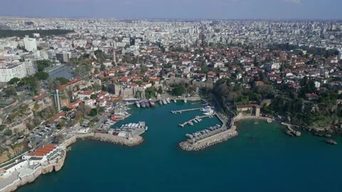 Aerial, the camera moves in a circle over the old city of Antalya from the sea Stock Footage 229795541