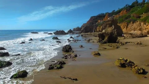 Aerial camera moving over rocks ad waves at El Matador Beach Malibu, Califronia Video stock 137360872