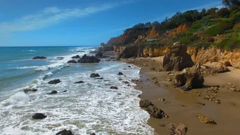 Aerial camera moving over rocks ad waves at El Matador Beach Malibu, Califronia Stock Footage 137361226