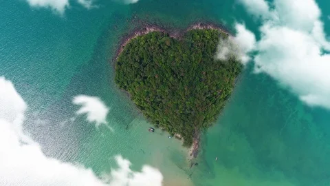 AERIAL. Camera moving trought clouds to heart shape island in Thailand. Video stock 86347843