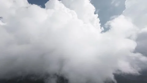 Aerial camera moving upward through large cumulus clouds Stock Footage 345161386