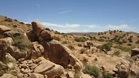 Aerial camera orbits striking rock formation, Sawtooth mountains, Yucca Valley Stock Footage 114135813