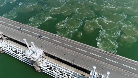 Aerial camera panning down over Oosterscheldekering 4k Stock Footage 76509306