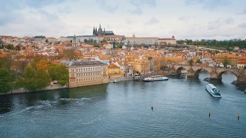 Aerial camera panning from river shot to the Charles Bridge and Prague Castle in Stock Footage 103223203