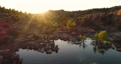 Aerial camera pull back from lake edge at sunset in Prescott Arizona Stock Footage 131400055