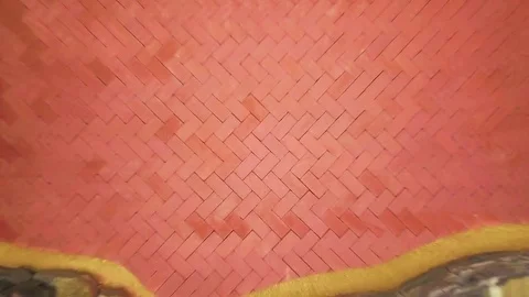 Aerial camera quickly ascends from a detail of herringbone brick paver pattern Stock Footage 82329877