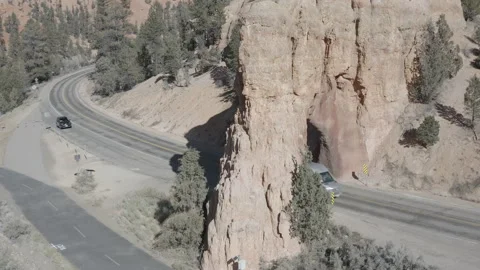 Aerial of camper van driving through natural arch by Red Canyon, Utah Stock-Footage 303389081