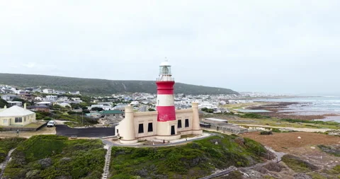 Aerial Cape Agulhas Lighthouse Overlooking Ocean and Coastal Village South Afric Stock Footage 330719192
