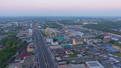 Aerial capture of Sam Phran skyline bathed in golden evening light, Thailand Stock Footage 304374276