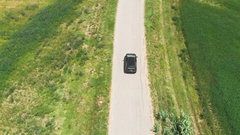 Aerial: Car Driving Along Empty Country Road At  Summer . Umbria region of Italy Stock Footage 99090841