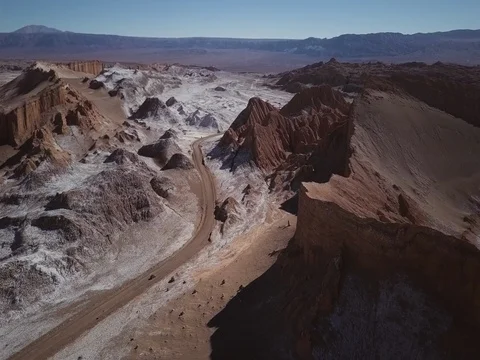 Aerial of car driving down road in Valle de Luna in Chile Stock Footage 83297553