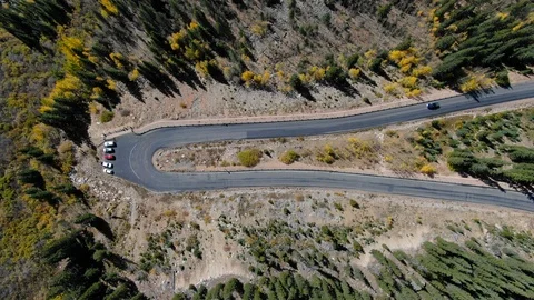 Aerial: Car Driving Down U-Shaped Road in Rockies - Breckenridge, Colorado Stock Footage 118237389