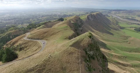 Aerial of car driving down a windy road at Te Mata Peak, New Zealand Stock Footage 68312971
