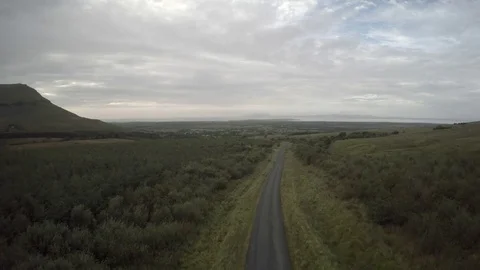 Aerial of car moving fast through countryside road Stock Footage 79822761