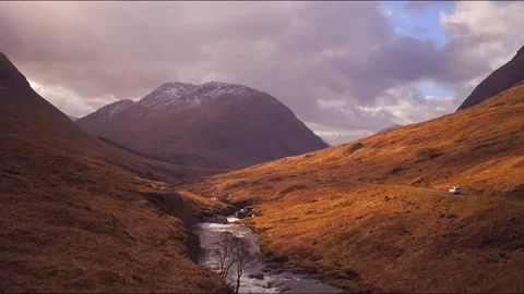 Aerial: Car tracking shot driving down a Scottish glen (Etive). 4K Stock Footage