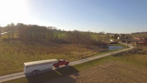 Aerial cattle farmer pulling his trailer into his farm. Video stock 102740693