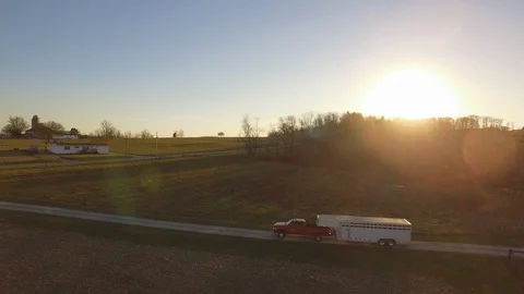 Aerial cattle farmer pulls trailer down driveway. Video stock 102740676
